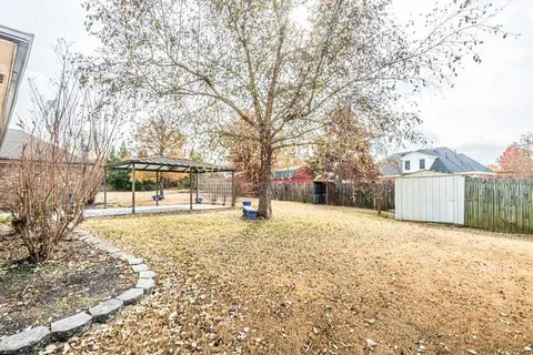 a front view of a house with a yard covered in snow