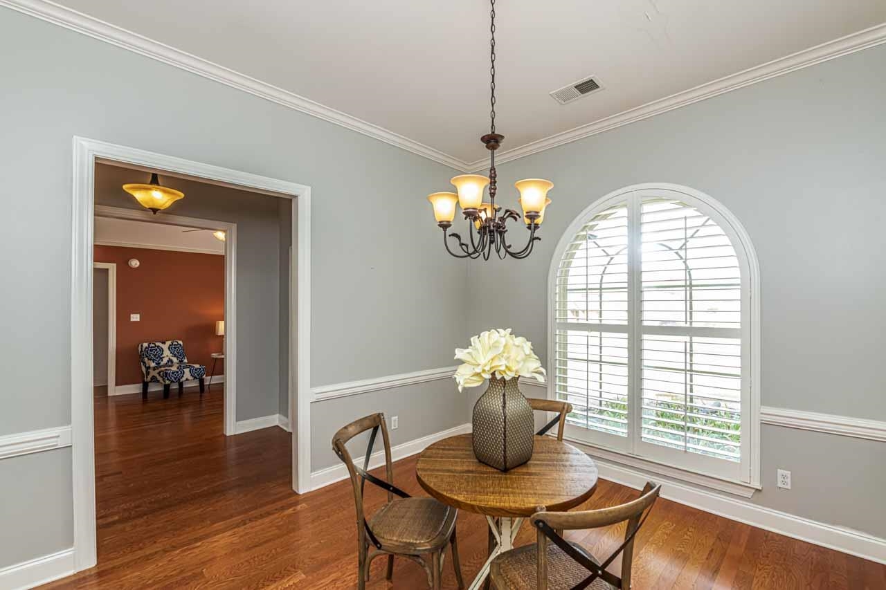 47 Clementine Road Atoka, TN 38004 - Photo 7 of 40 a dining room with furniture a chandelier and wooden floor