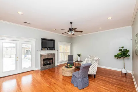 a living room with furniture a fireplace and a flat screen tv