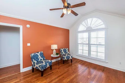 a living room with furniture and a wooden floor