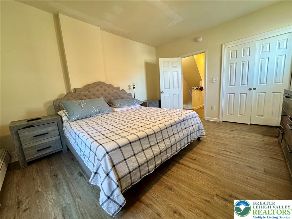 414 Washington Street Allentown, PA 18102 - Photo 11 of 23 a bedroom with a bed and wooden floor