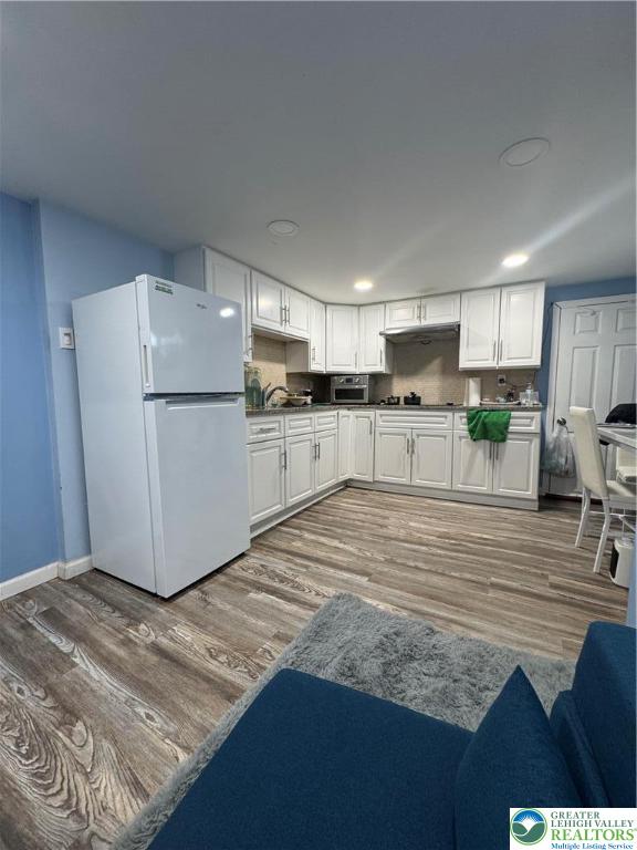 414 Washington Street Allentown, PA 18102 - Photo 20 of 23 a kitchen with refrigerator cabinets and wooden floor
