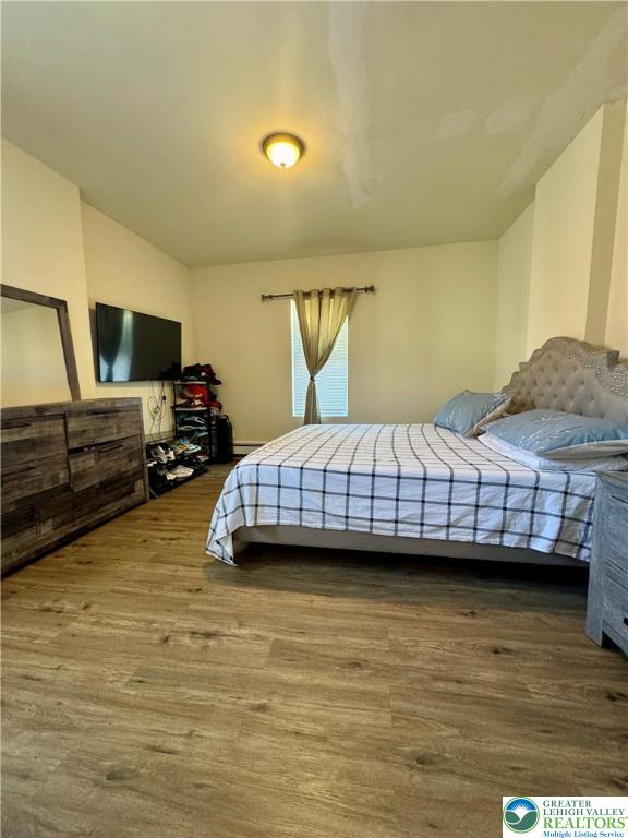 414 Washington Street Allentown, PA 18102 - Photo 10 of 23 a bedroom with a bed and a flat screen tv