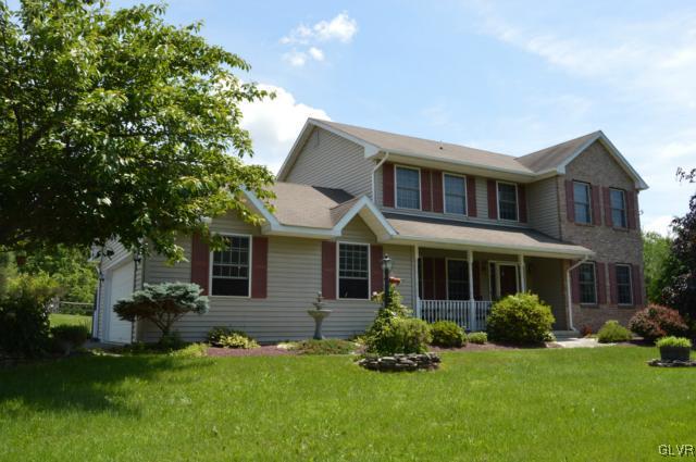 6168 Mud Run Road Nazareth, PA 18064 - Photo 1 of 35 a front view of a house with a garden and plants