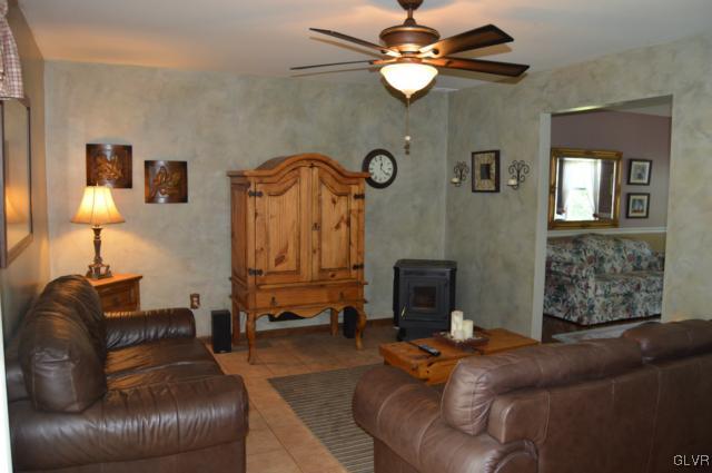 6168 Mud Run Road Nazareth, PA 18064 - Photo 12 of 35 a living room with furniture a fireplace and a chandelier