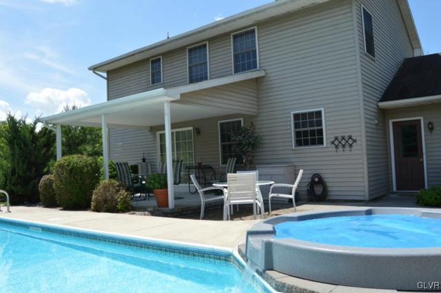 6168 Mud Run Road Nazareth, PA 18064 - Photo 32 of 35 a view of a house with backyard sitting area and garden