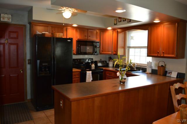 6168 Mud Run Road Nazareth, PA 18064 - Photo 7 of 35 a kitchen with stainless steel appliances granite countertop a refrigerator a sink a stove and a microwave