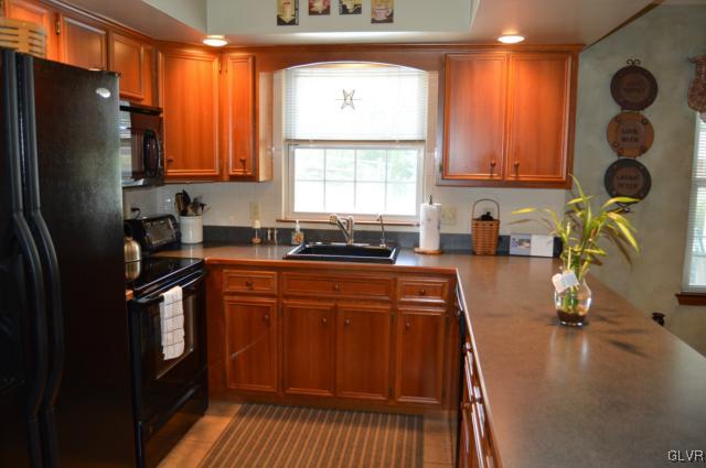6168 Mud Run Road Nazareth, PA 18064 - Photo 8 of 35 a kitchen with stainless steel appliances granite countertop a refrigerator a sink a stove and island