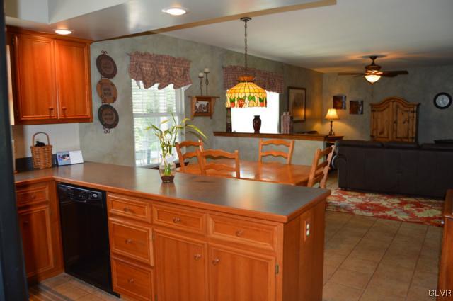 6168 Mud Run Road Nazareth, PA 18064 - Photo 9 of 35 a kitchen with stainless steel appliances granite countertop a sink a stove and a wooden cabinets