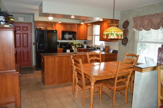 6168 Mud Run Road Nazareth, PA 18064 - Photo 10 of 35 a kitchen with stainless steel appliances kitchen island granite countertop a table and chairs in it