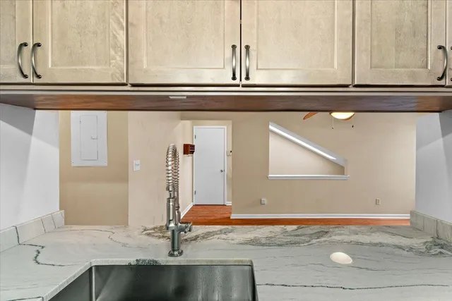 a view of kitchen with granite countertop window and sink