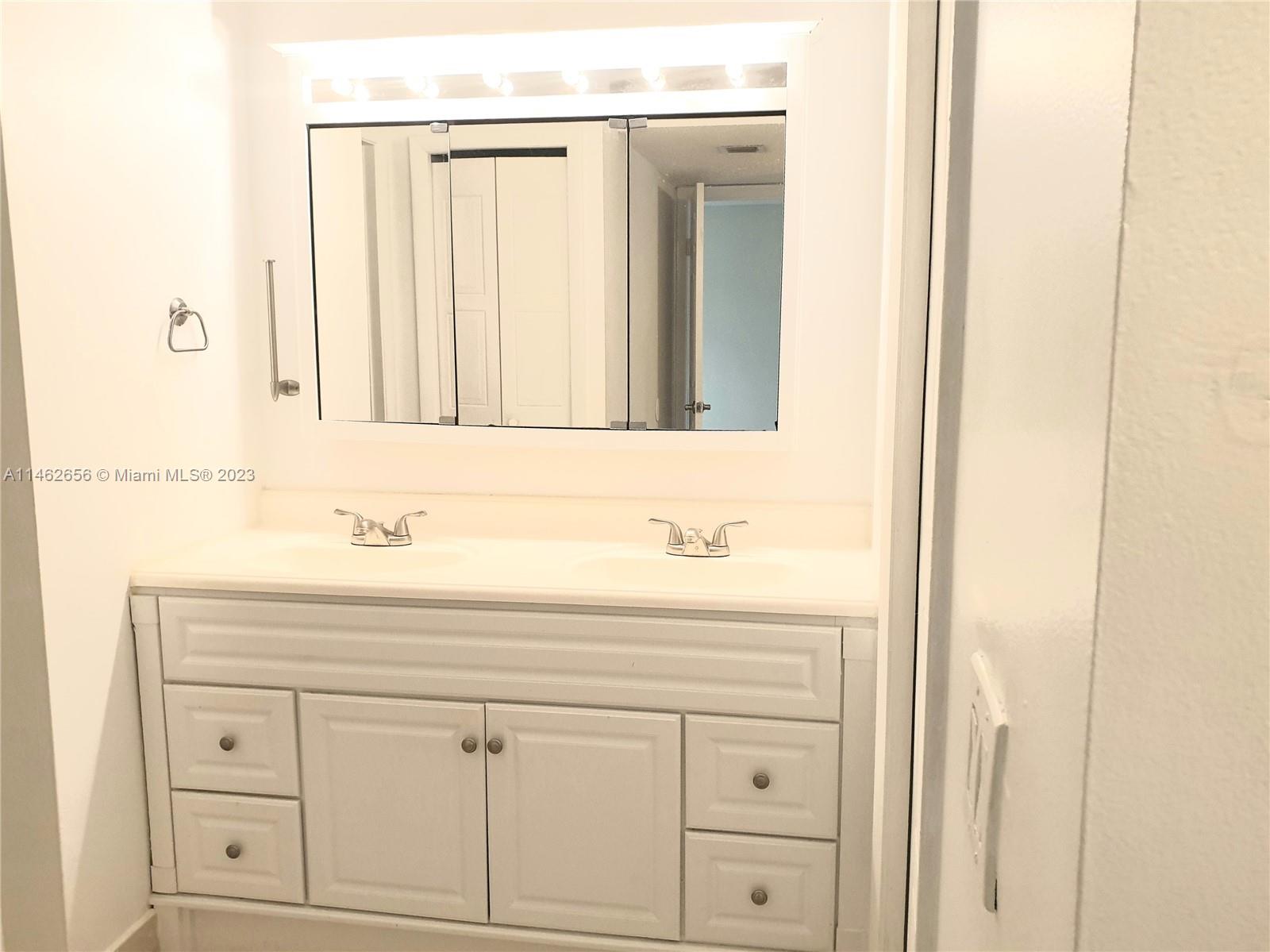 380 Racquet Club Road, Unit 202 Weston, FL 33326 - Photo 12 of 34 a bathroom with a sink and a mirror