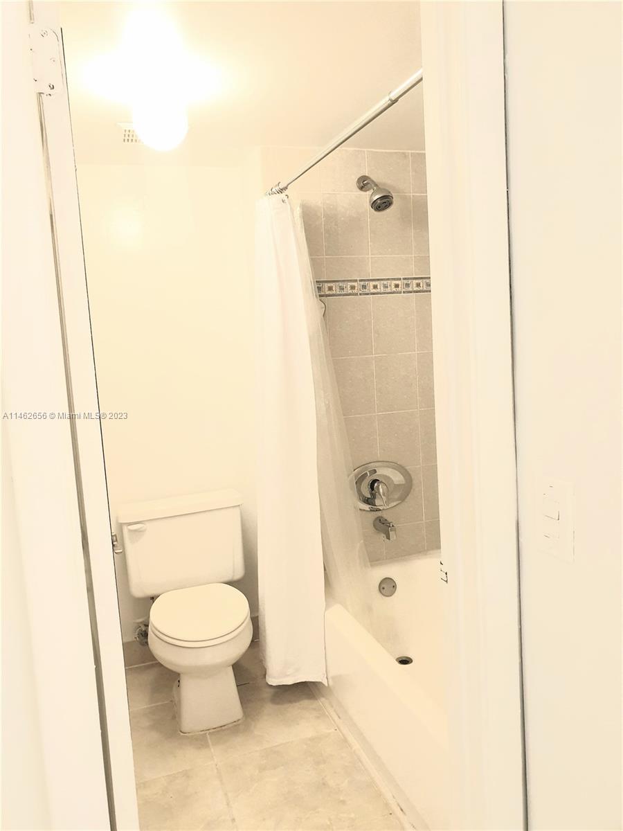 380 Racquet Club Road, Unit 202 Weston, FL 33326 - Photo 13 of 34 a bathroom with a toilet and a shower