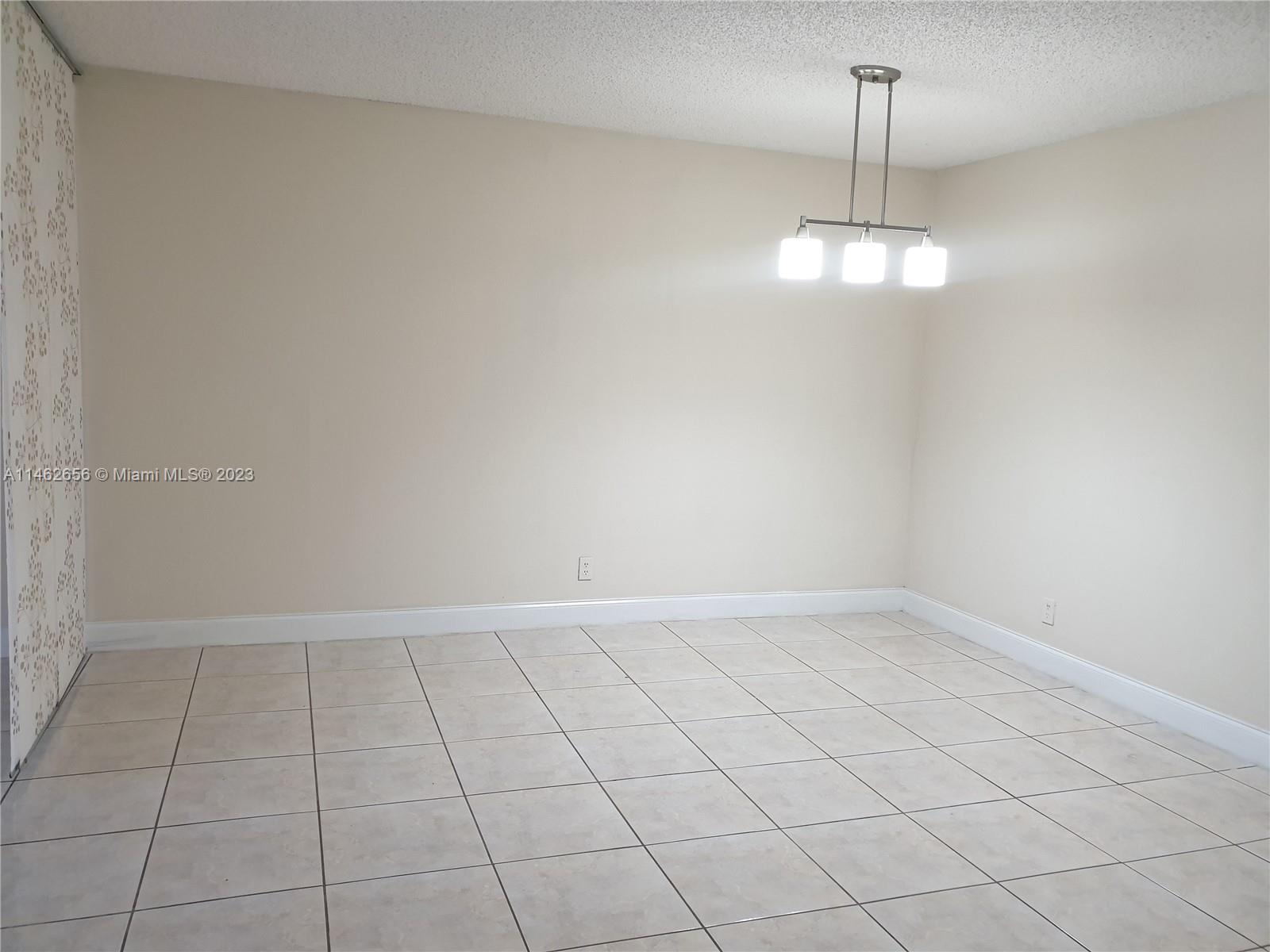 380 Racquet Club Road, Unit 202 Weston, FL 33326 - Photo 14 of 34 a view of empty room with wooden floor