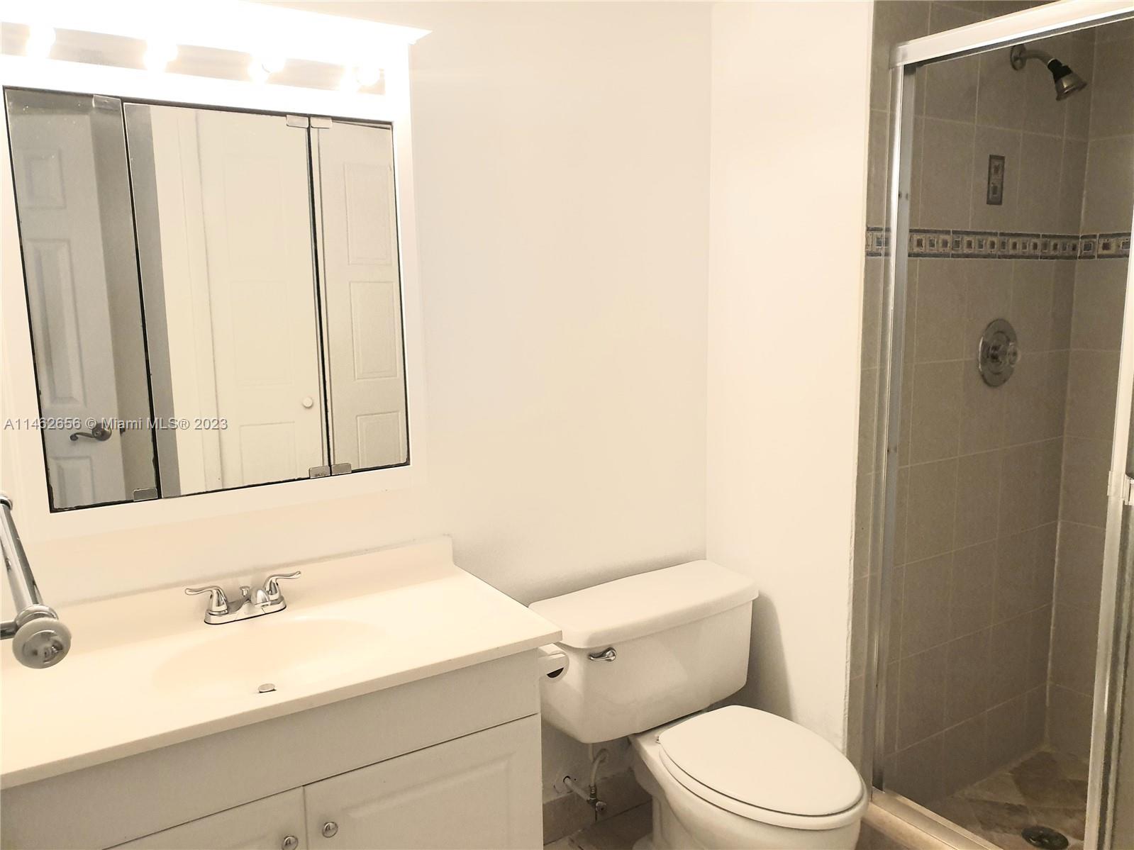 380 Racquet Club Road, Unit 202 Weston, FL 33326 - Photo 17 of 34 a bathroom with a sink a toilet and shower