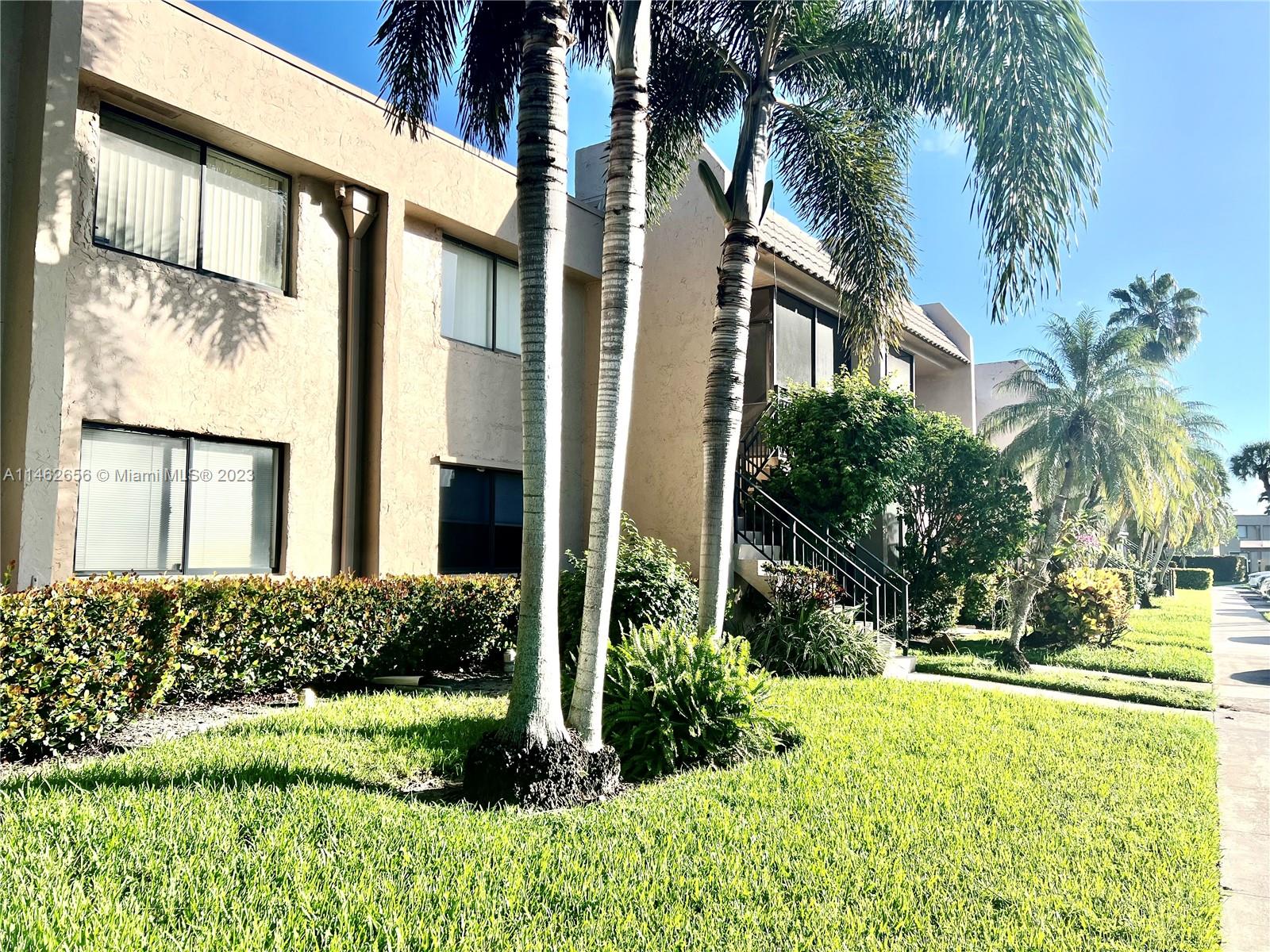380 Racquet Club Road, Unit 202 Weston, FL 33326 - Photo 20 of 34 front view of a house with a yard