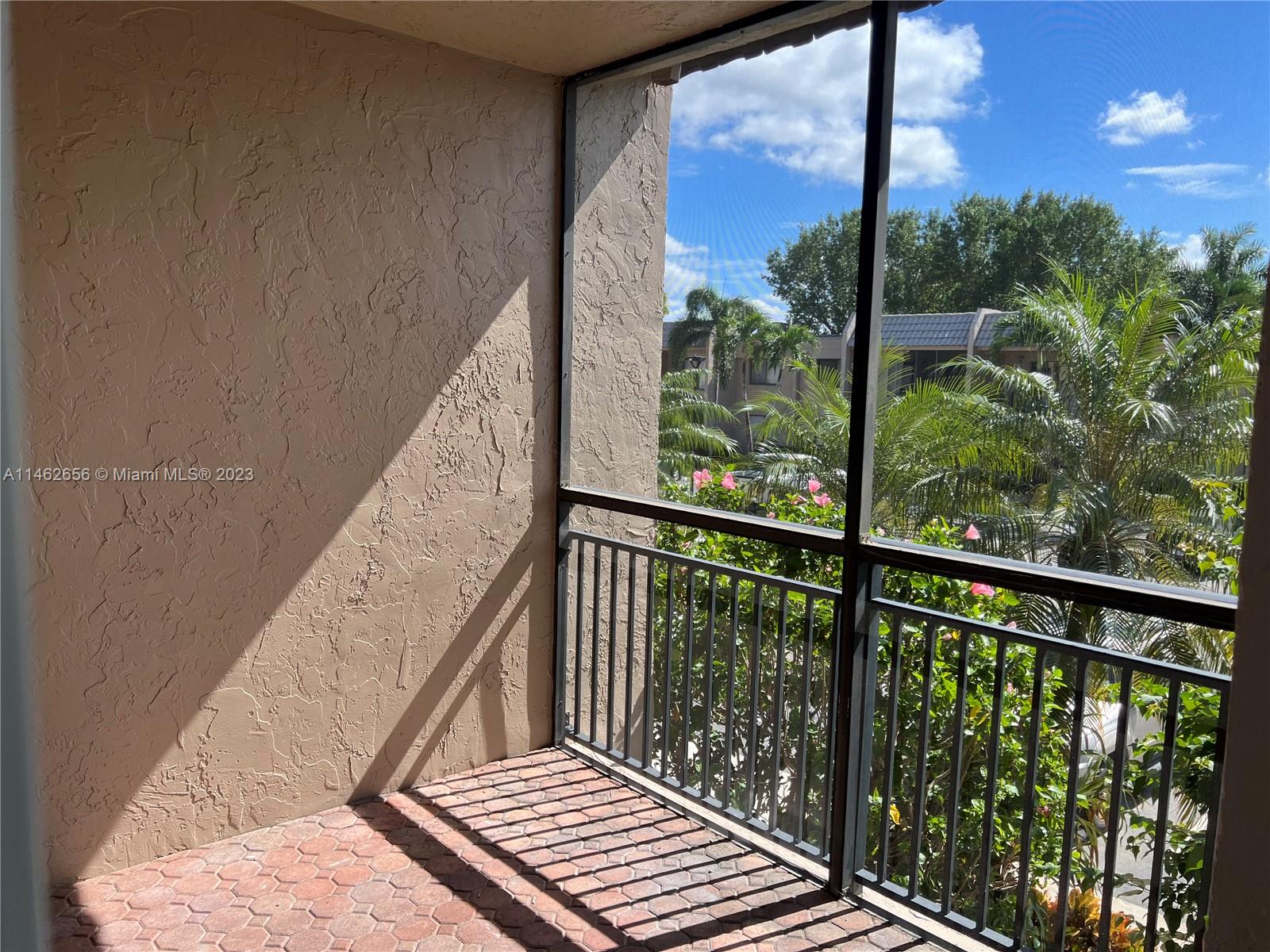 380 Racquet Club Road, Unit 202 Weston, FL 33326 - Photo 33 of 34 a view of balcony with wooden floor and fence