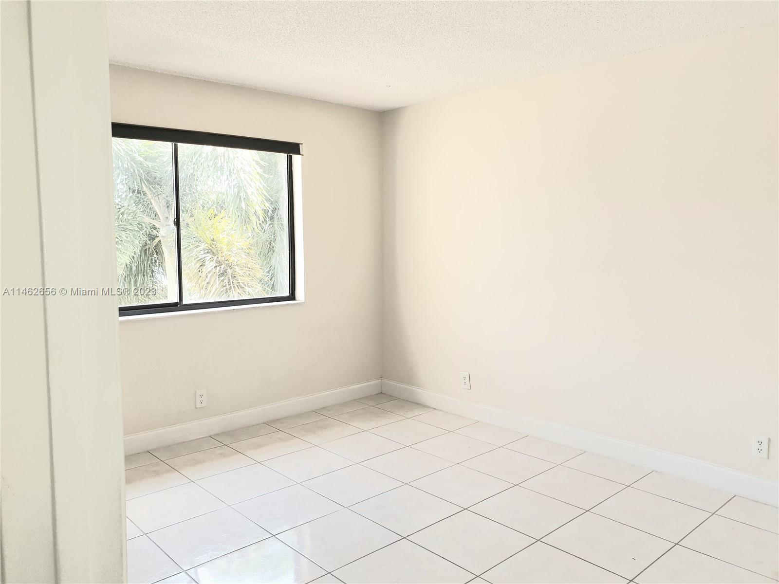 380 Racquet Club Road, Unit 202 Weston, FL 33326 - Photo 6 of 34 an empty room with a window
