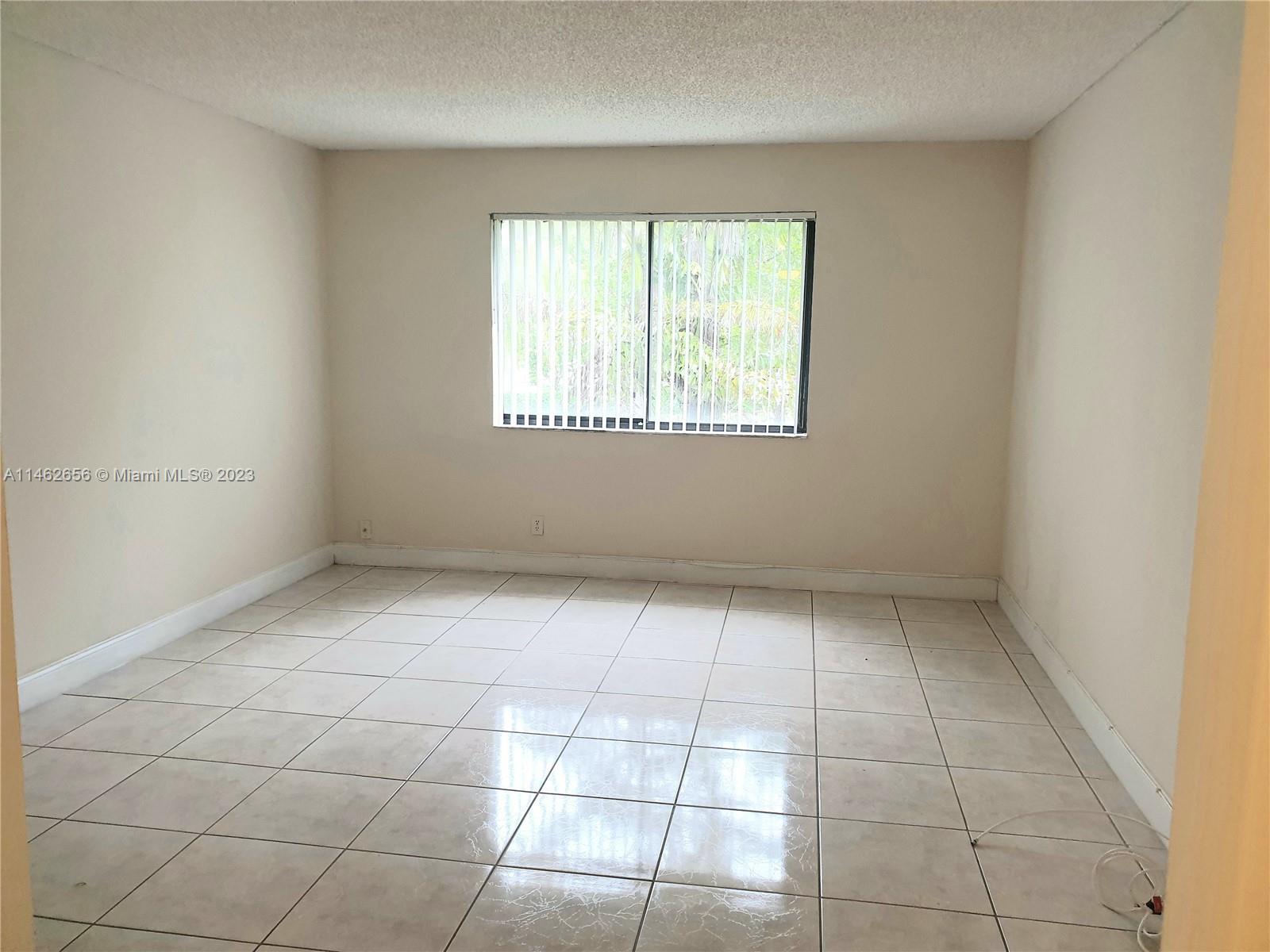 380 Racquet Club Road, Unit 202 Weston, FL 33326 - Photo 10 of 34 an empty room with a window