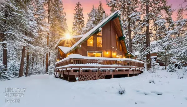 a view of house with a yard and covered trees