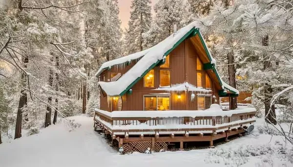 a view of house with swimming pool and sitting area