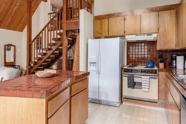 a kitchen with stainless steel appliances granite countertop a stove and a refrigerator