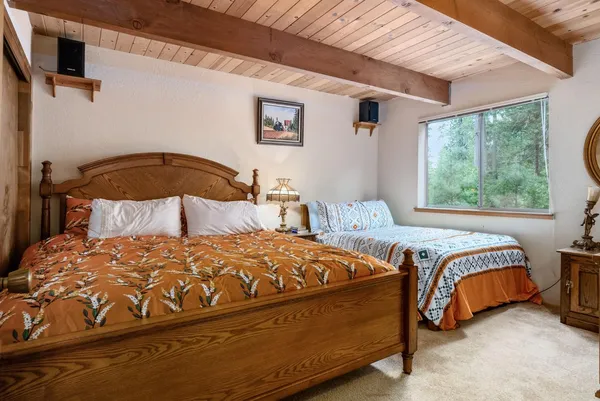 a bedroom with two beds and a window