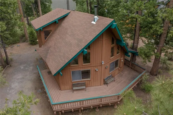 an aerial view of a house with a yard