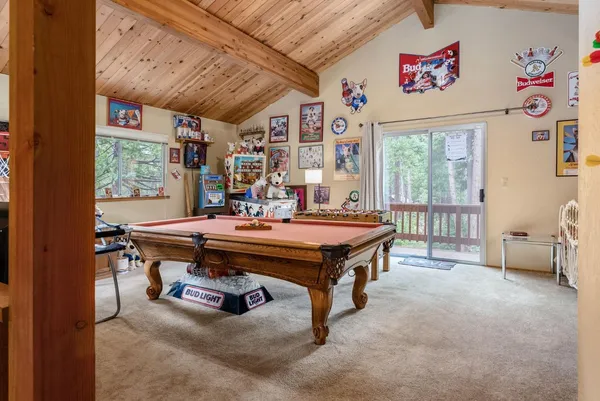 a room with pool table and windows