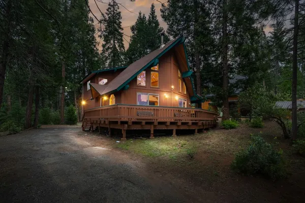 a view of a house with a yard and sitting area