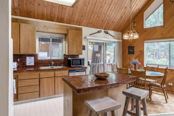 a kitchen with a dining table and chairs