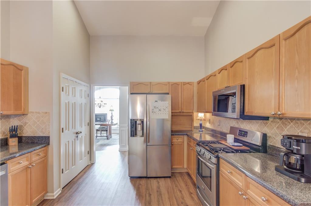 2630 Snowcrest Place Bethlehem, GA 30620 - Photo 13 of 39 a kitchen with stainless steel appliances granite countertop a refrigerator stove and sink