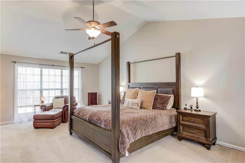 2630 Snowcrest Place Bethlehem, GA 30620 - Photo 15 of 39 a bedroom with a bed and a chandelier