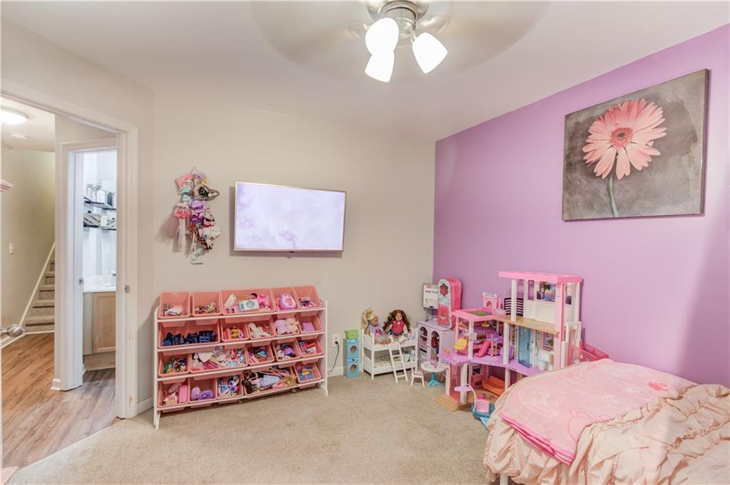 2630 Snowcrest Place Bethlehem, GA 30620 - Photo 21 of 39 a bedroom with a bed and a chandelier