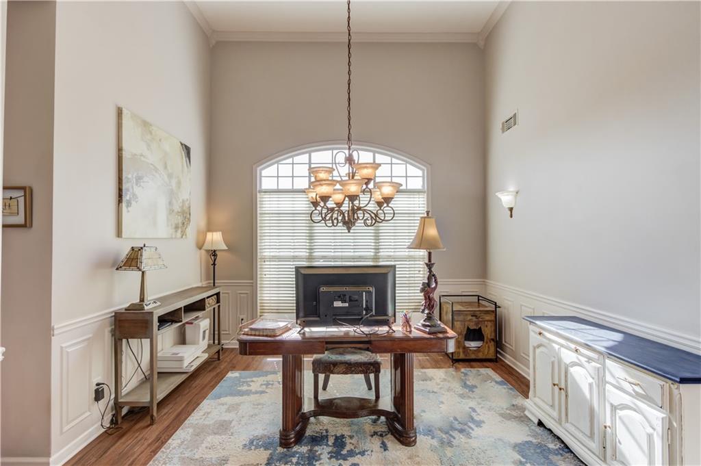 2630 Snowcrest Place Bethlehem, GA 30620 - Photo 7 of 39 a living room with furniture a fireplace and a chandelier