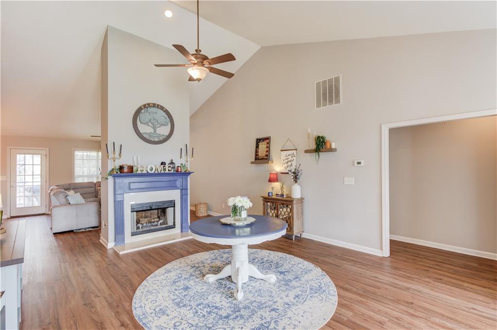 2630 Snowcrest Place Bethlehem, GA 30620 - Photo 8 of 39 a living room with furniture a fireplace and wooden floor