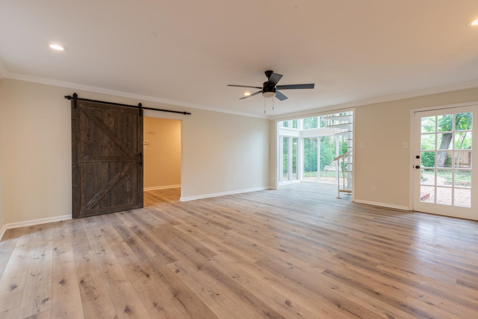 505 Thorn Ridge Cove Memphis, TN 38117 - Photo 16 of 31 a view of an empty room with wooden floor and a window