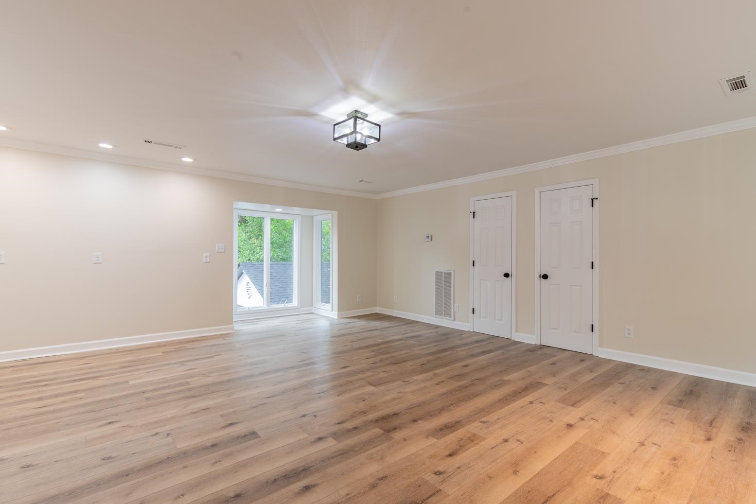 505 Thorn Ridge Cove Memphis, TN 38117 - Photo 5 of 31 a view of an empty room with wooden floor and a window