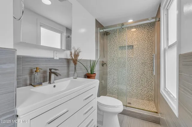 a bathroom with a sink toilet and shower