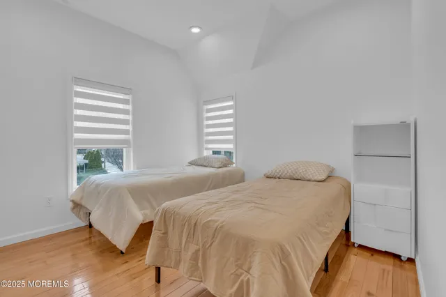 a bedroom with two beds and a window