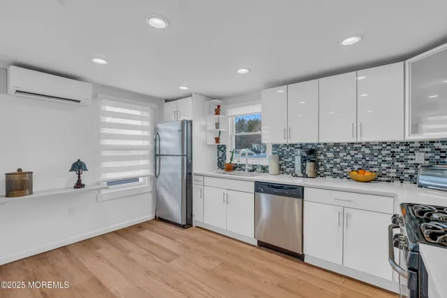 a kitchen with stainless steel appliances a refrigerator and a sink