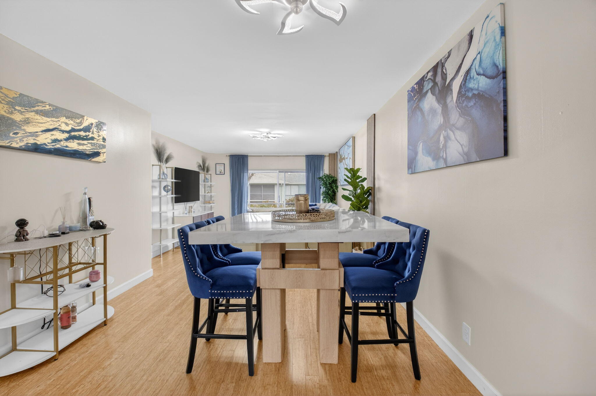 2340 Southwest 22nd Avenue, Unit 312 Delray Beach, FL 33445 - Photo 11 of 45 a view of a dining room with furniture and wooden floor