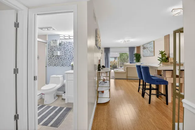 a living room with furniture a dining table and a large window