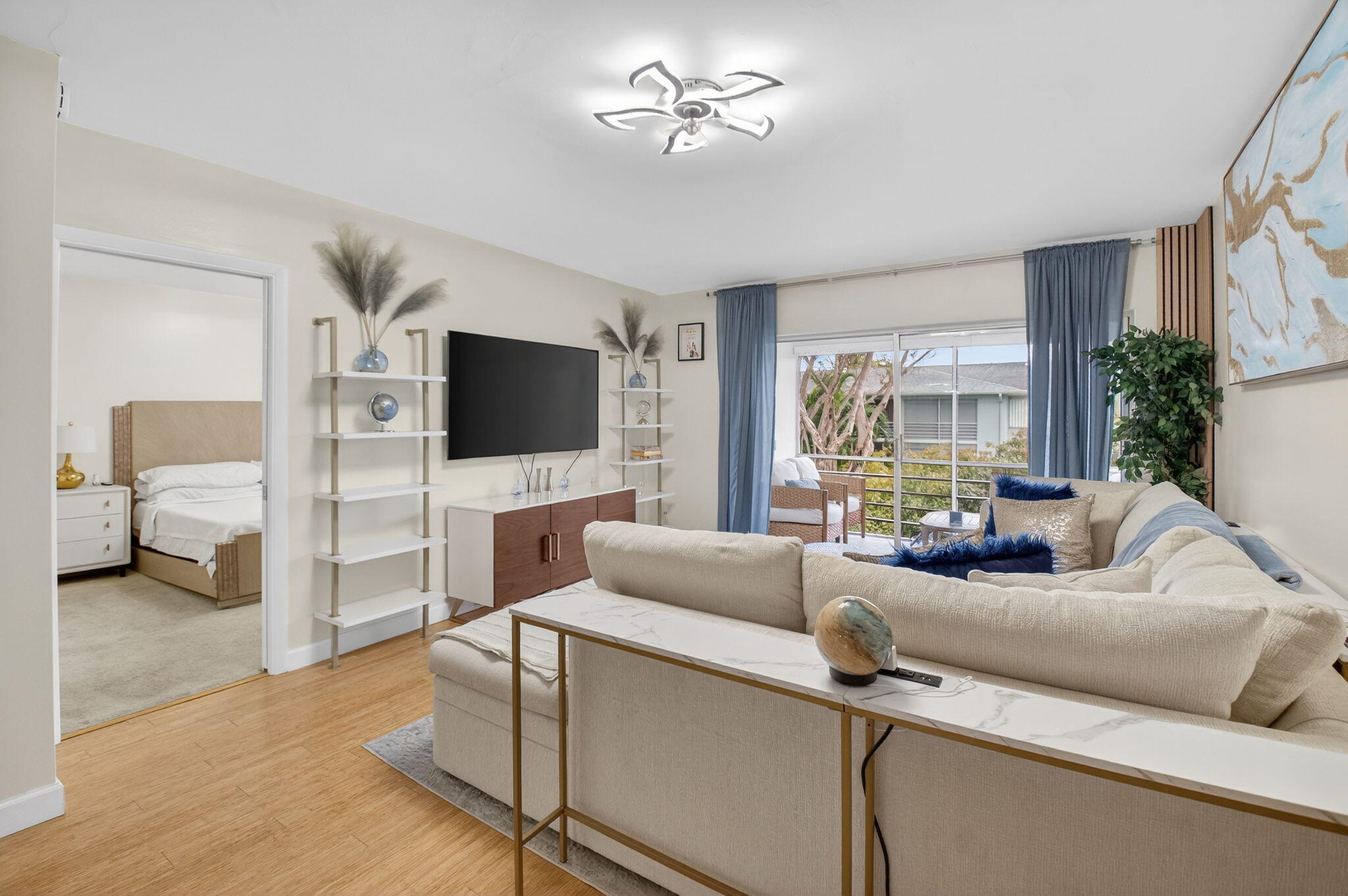 2340 Southwest 22nd Avenue, Unit 312 Delray Beach, FL 33445 - Photo 15 of 45 a living room with furniture and a flat screen tv