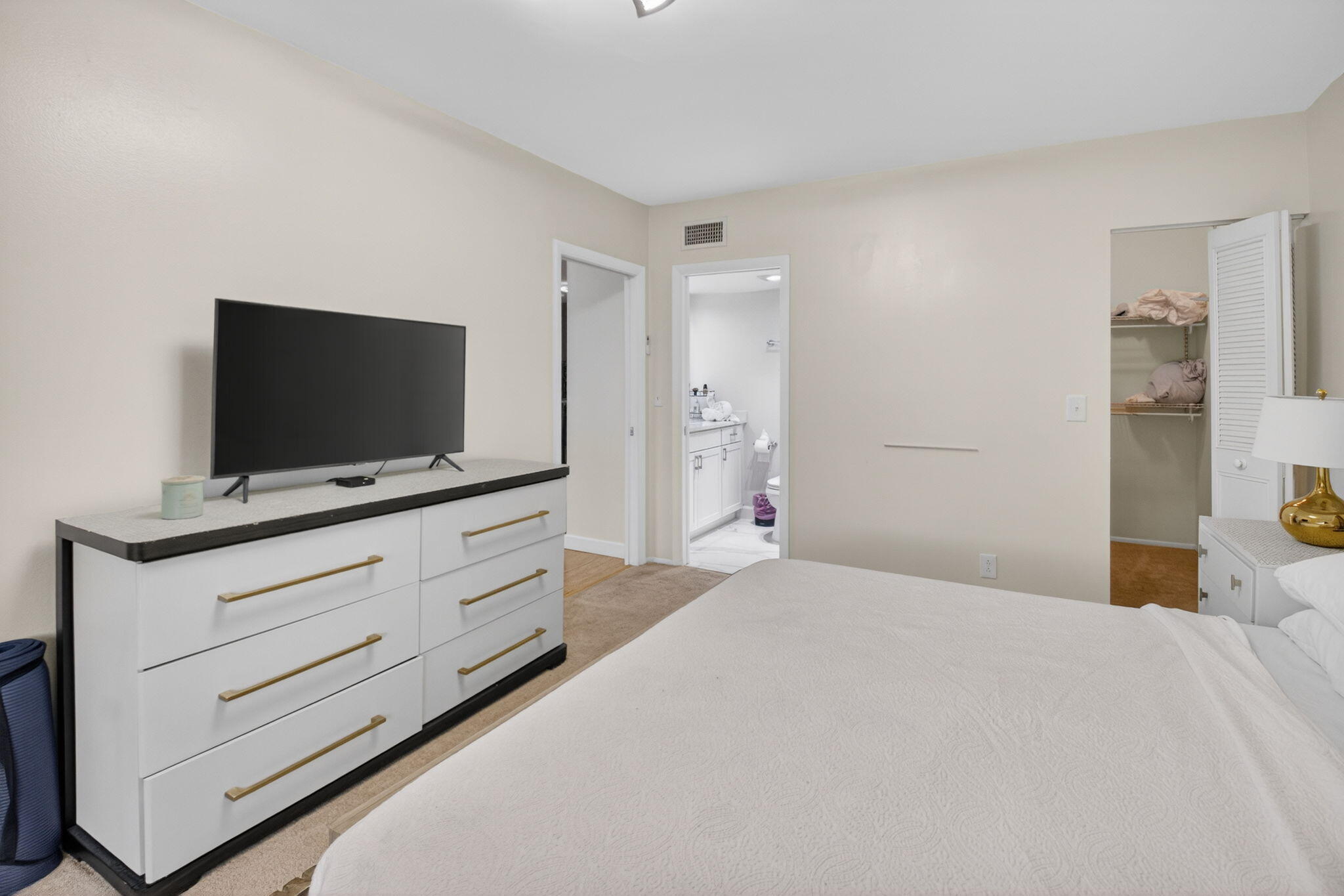 2340 Southwest 22nd Avenue, Unit 312 Delray Beach, FL 33445 - Photo 19 of 45 a bedroom with a bed and flat screen tv