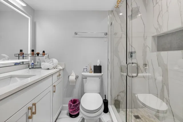 a bathroom with a sink toilet and shower