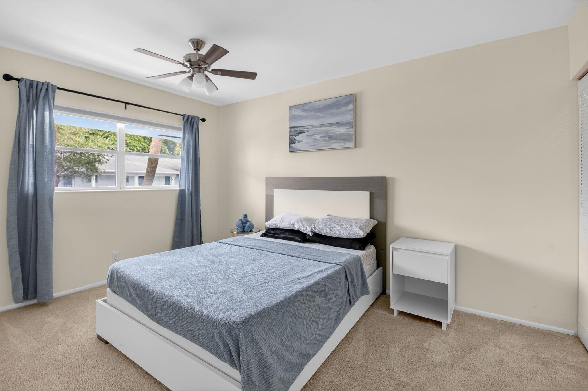 2340 Southwest 22nd Avenue, Unit 312 Delray Beach, FL 33445 - Photo 24 of 45 a bedroom with a bed and a table