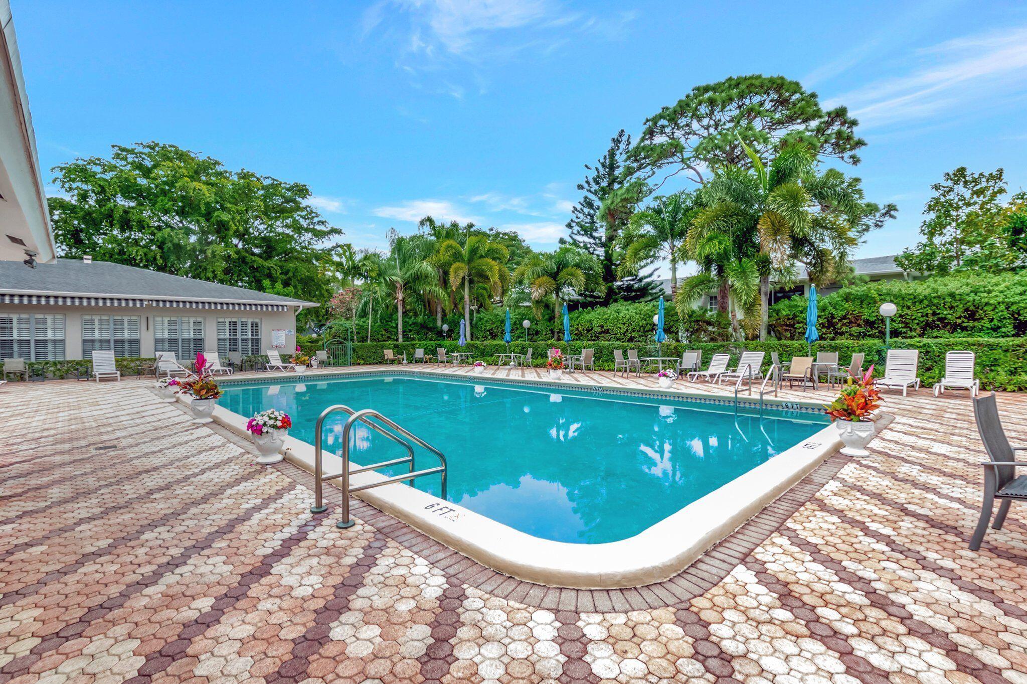 2340 Southwest 22nd Avenue, Unit 312 Delray Beach, FL 33445 - Photo 38 of 45 a view of a swimming pool with a patio