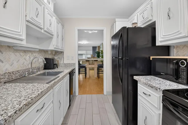 a kitchen with a sink stove and refrigerator