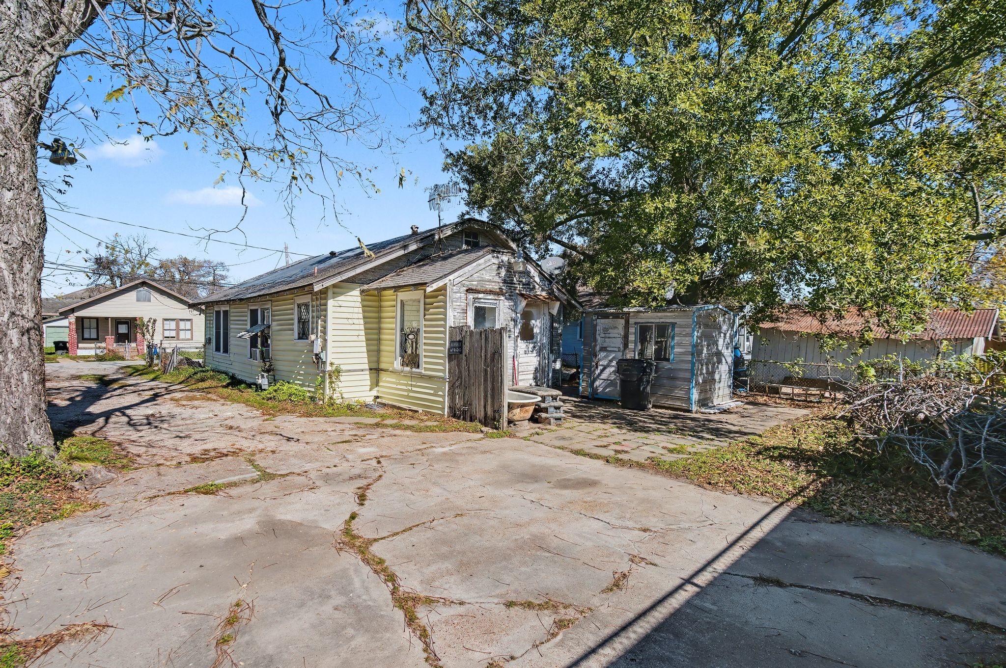 1218 Genova Street Houston, TX 77009 - Photo 9 of 15 a view of a house with large tree and wooden fence